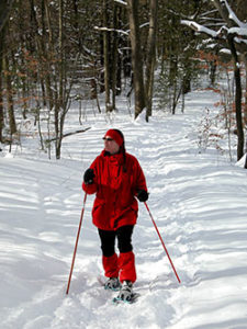 Patty Zwers snowshoes in Saugatuck State Park.